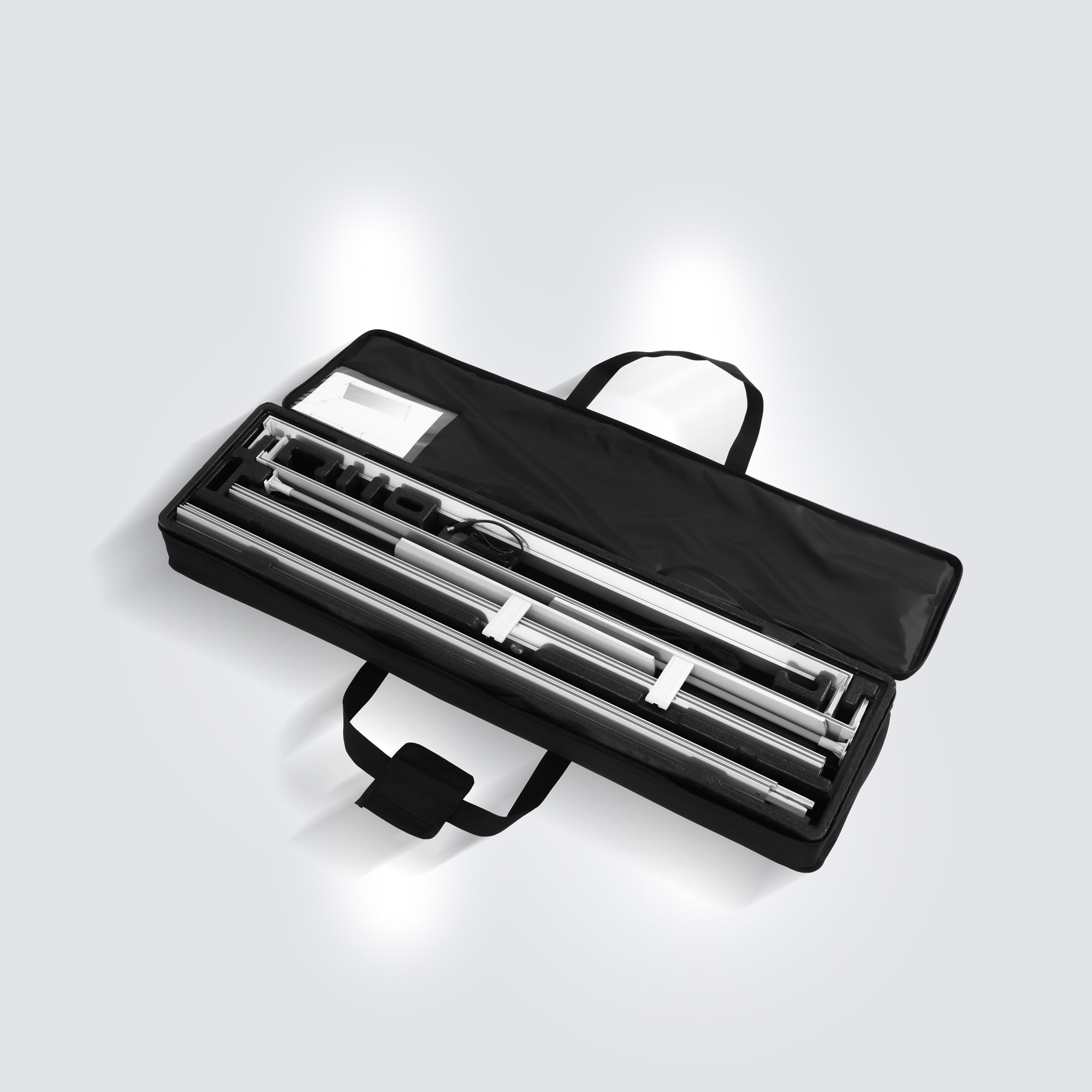 unassembled view of the 80mm aluminum frame profile, internal wiring, and LED components inside the carrying case for Qseg 80 Double-Sided Light Box Essential