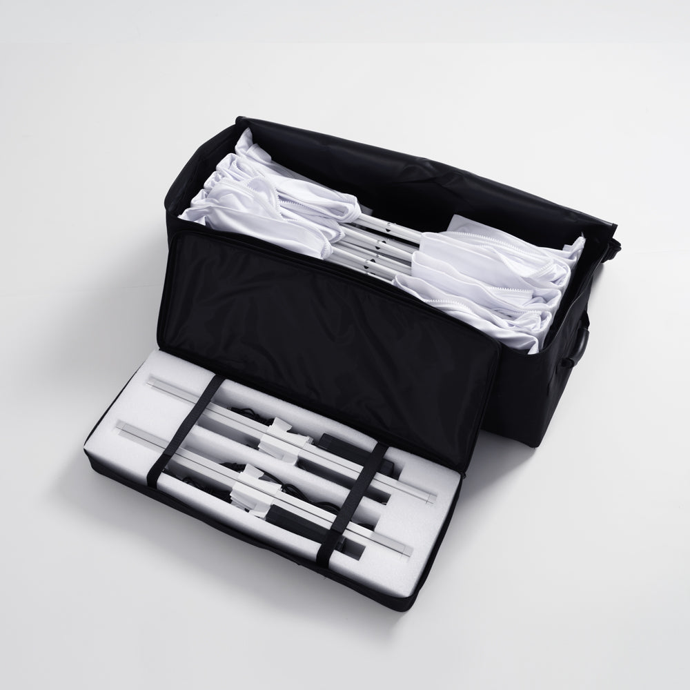 Portable travel bag containing a full set of unassembled aluminum scissor frame profiles and SEG fabric graphics for a 10ft Fabric Popup Light Box