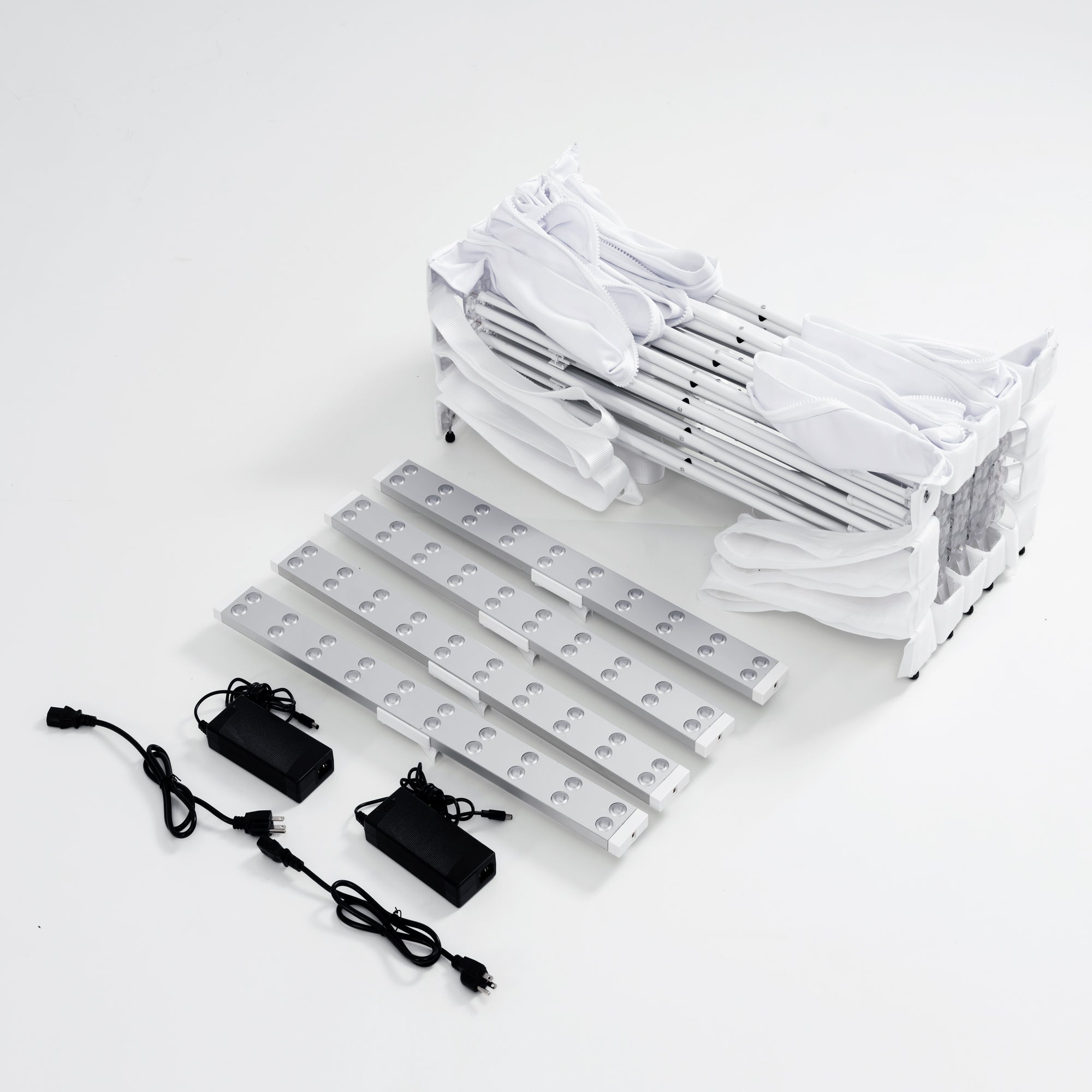 Internal components of 10ft Fabric Popup Light Box: Folded aluminum scissor frame, edge-lit LED bars, and power adapters