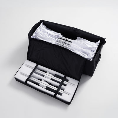 Portable travel bag containing a full set of unassembled aluminum scissor frame profiles and SEG fabric graphics for a 10ft Fabric Popup Light Box