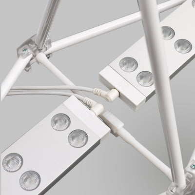 Edge-lit LED bars for shadow-free illumination on fabric popup booth