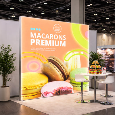 Left perspective view of a 10ft wide Qseg 60 single-sided LED light box backdrop, featuring a custom premium macarons retail graphic.